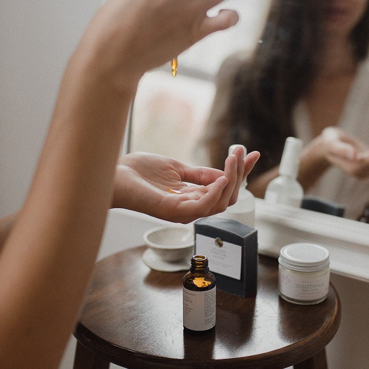 oil facial serum being dropped into hand