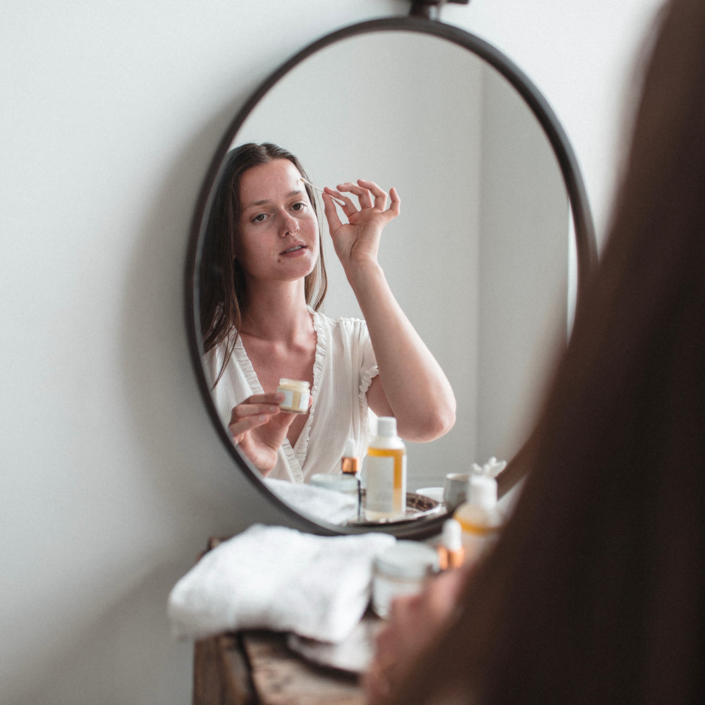 woman applying spot treatment