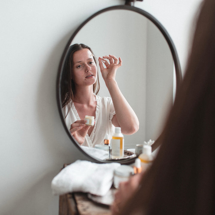 woman applying spot treatment