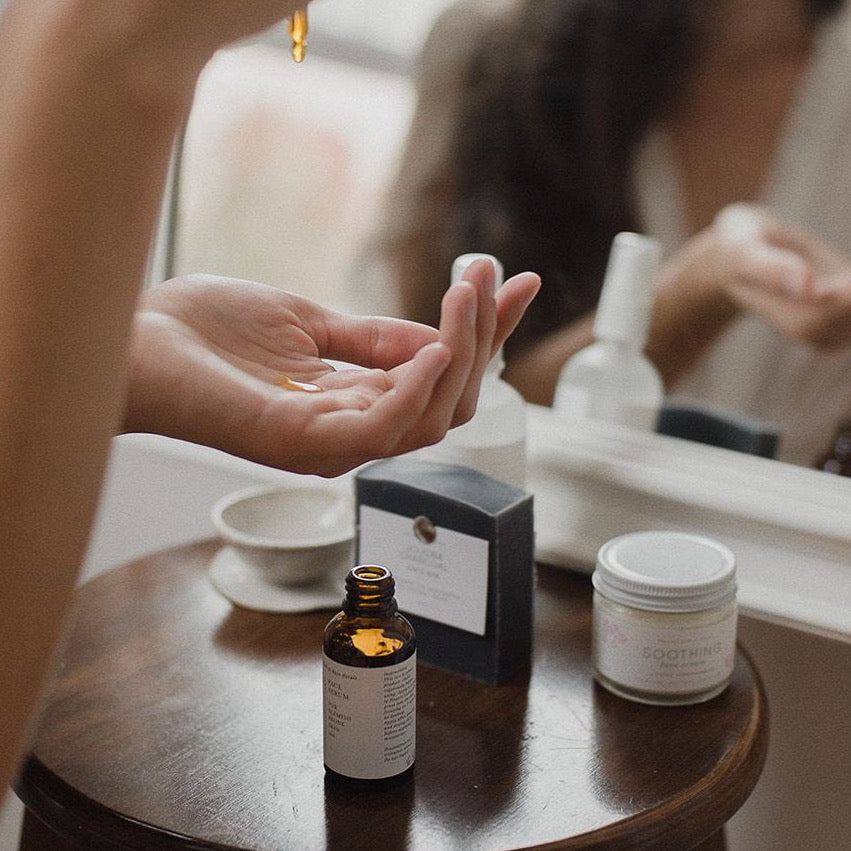 face serum being dropped into palm