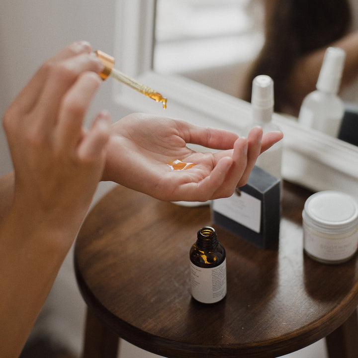 face serum dropping into had