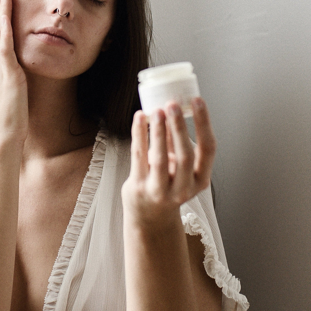 women applying soothing face cream