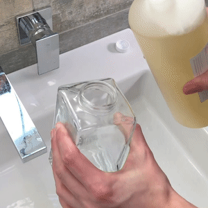 Pouring Castile soap into jar