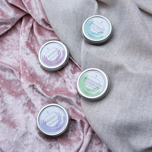 Charcoal and rose petals women’s deodorant collection on purple linen and velvet