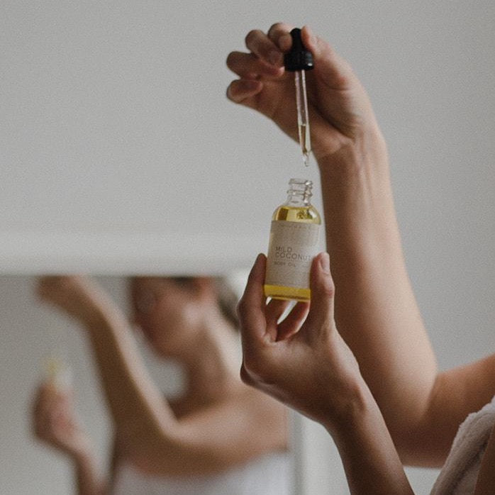 Vegan Body Oil - Mild Coconut being droppered