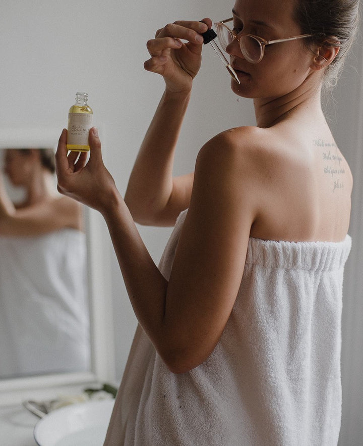 Vegan Body Oil being dropped onto skin of woman