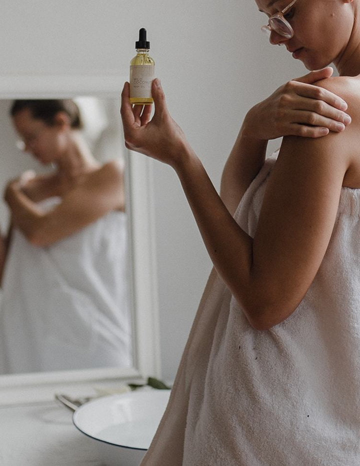 Vegan Body OIl being rubbed into skin by woman