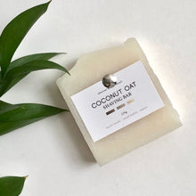 Load image into Gallery viewer, coconut oat vegan shaving bar next to leaf